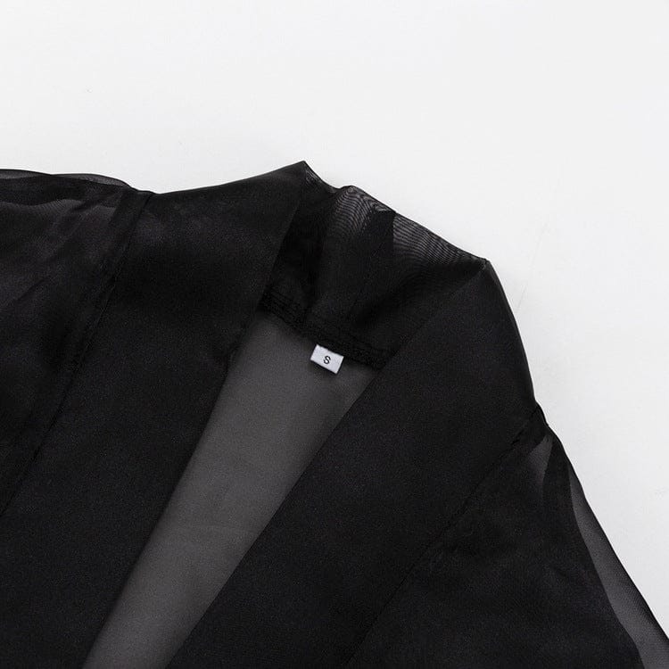 Elegant Noir Kimono by Serena Ken, featuring a flowing design and luxurious fabric, draped gracefully on a mannequin.