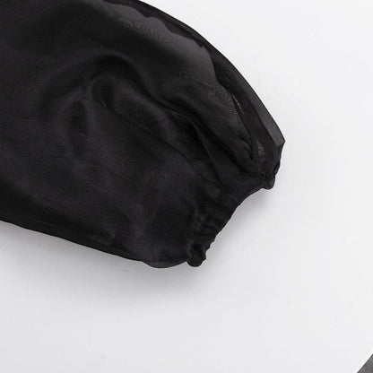 Elegant noir kimono by Serena Ken, featuring flowing sleeves and a classic silhouette on a neutral background.
