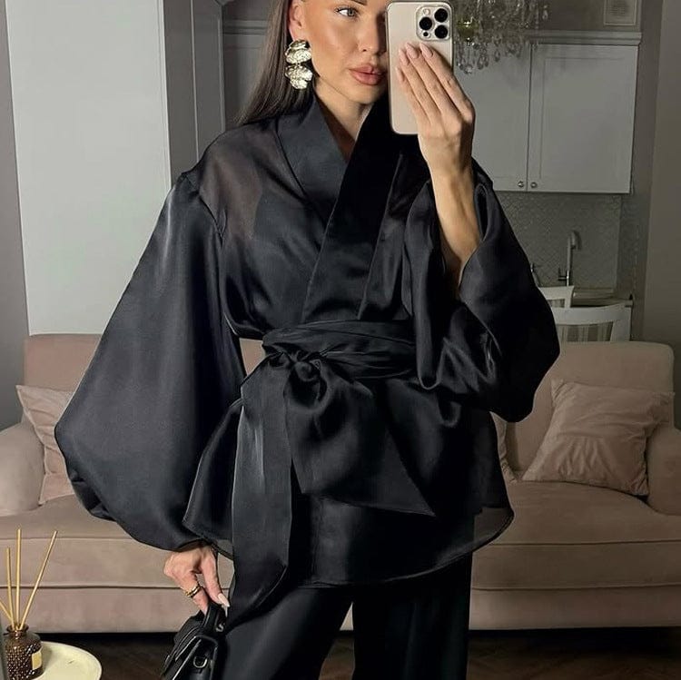 Elegant black kimono by Serena Ken with flowing sleeves and intricate detailing, perfect for layering over outfits.