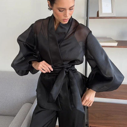 Elegant black kimono by Serena Ken, featuring flowing sleeves and a stylish silhouette, perfect for layering over outfits.