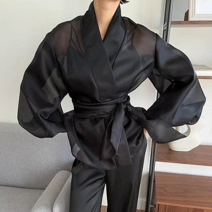 Elegant black kimono by Serena Ken, featuring flowing sleeves and a lightweight design, perfect for layering.