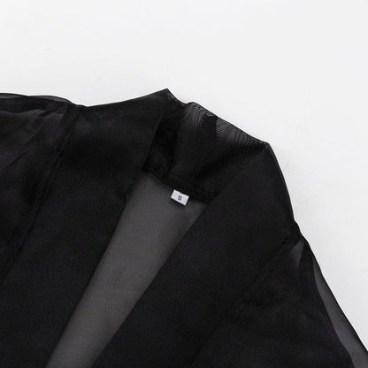 Elegant Noir Kimono by Serena Ken, featuring a flowing design and luxurious fabric, draped gracefully on a mannequin.